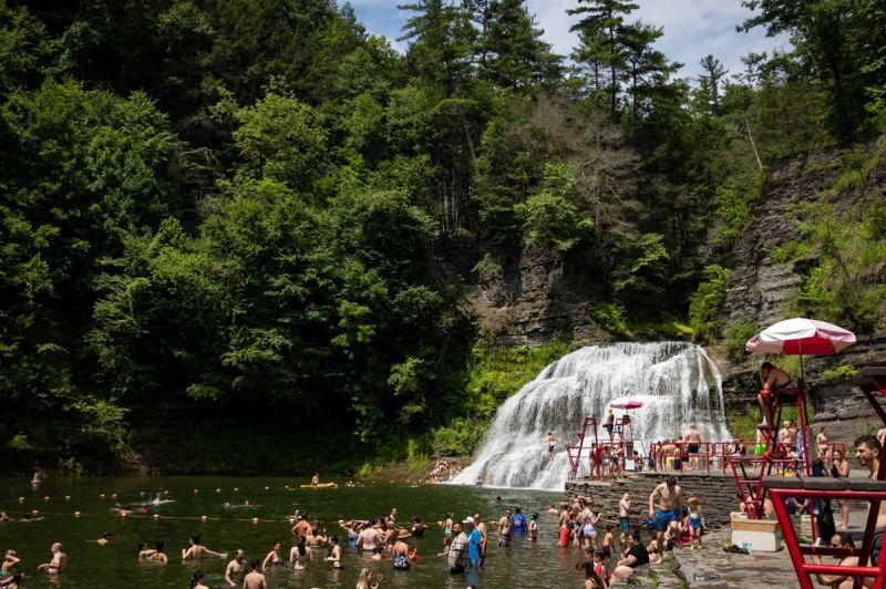 Beneath Enfield Falls, a stream-fed natural pool with amenities like a diving board, one of New York's many swimming holes