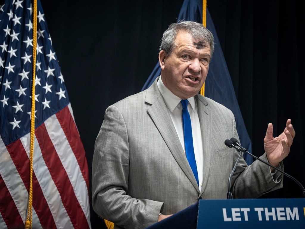 George Latimer speaking at a lectern