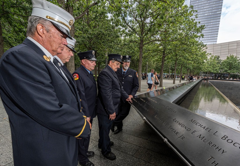 men in uniform stand at 9/11 memorial