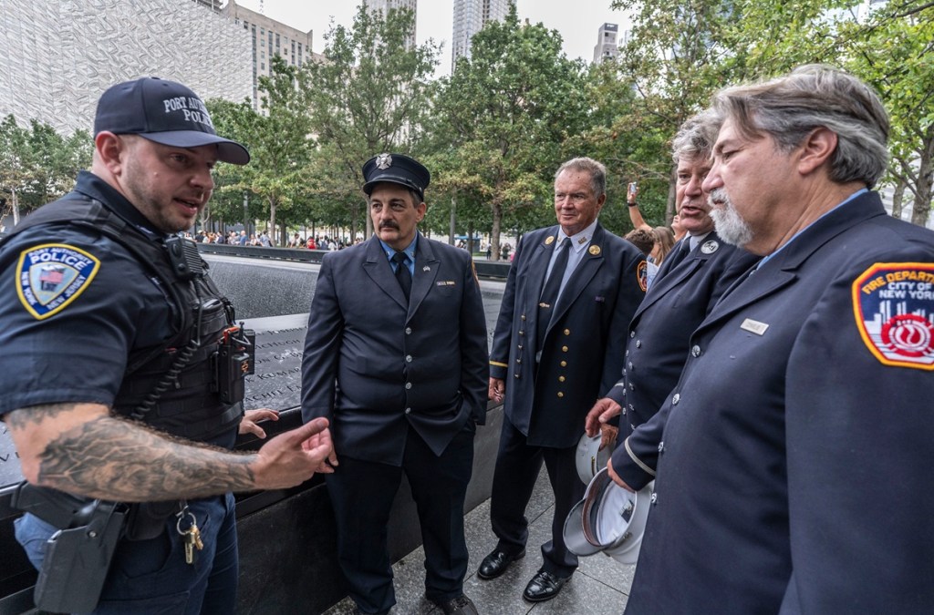 men discuss things at 9/11 memorial